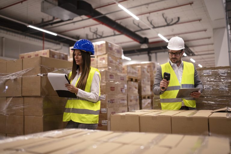 warehouse workers using bar code scanner and tablet and checking goods inventory